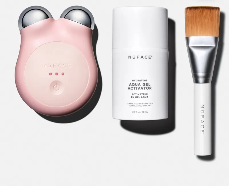 NuFACE MINI+ microcurrent device in pink with its starter kit on white